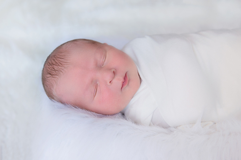 Wrapped Newborn Boy on White