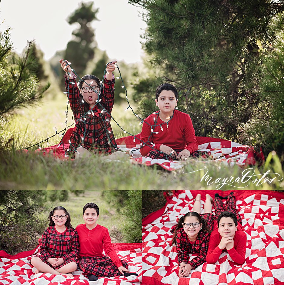 Brother and sister playing with Christmas lights next to an outdoor pine tree