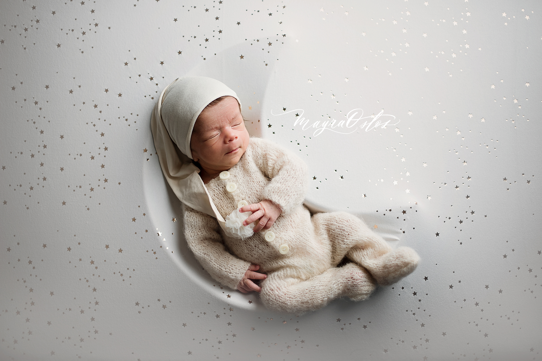 Newborn asleep on moon